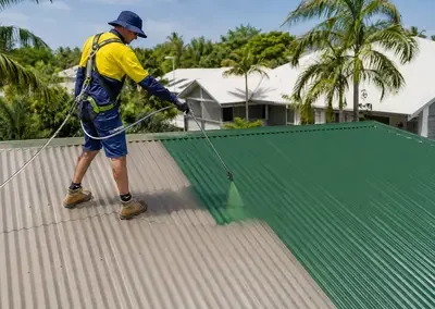 Metal roof being recoated as part of a roof restoration in Darwin
