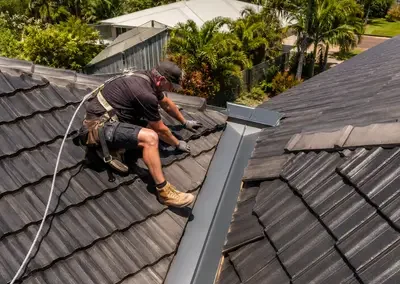 Roofing work being carried out around a tiled roof valley