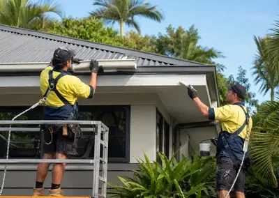 Roofing team working around the gutter and fascia of a residential home